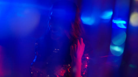 Close-Up-Of-Woman-In-Nightclub-Bar-Or-Disco-Dancing-With-Sparkling-Lights-4